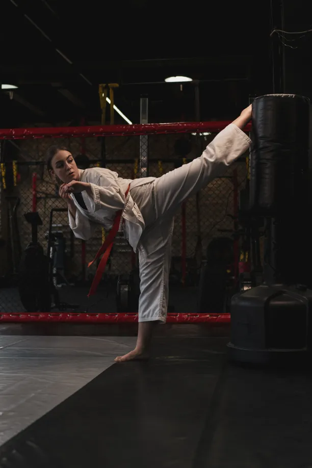 A taekwondo athlete throwing a high kick